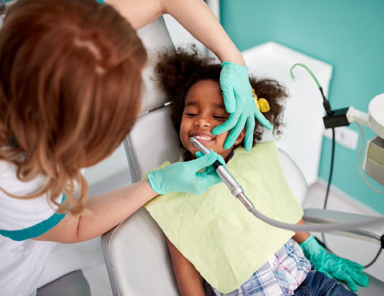 young girl getting her teeth cleaned