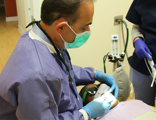 dentist checking patient's teeth