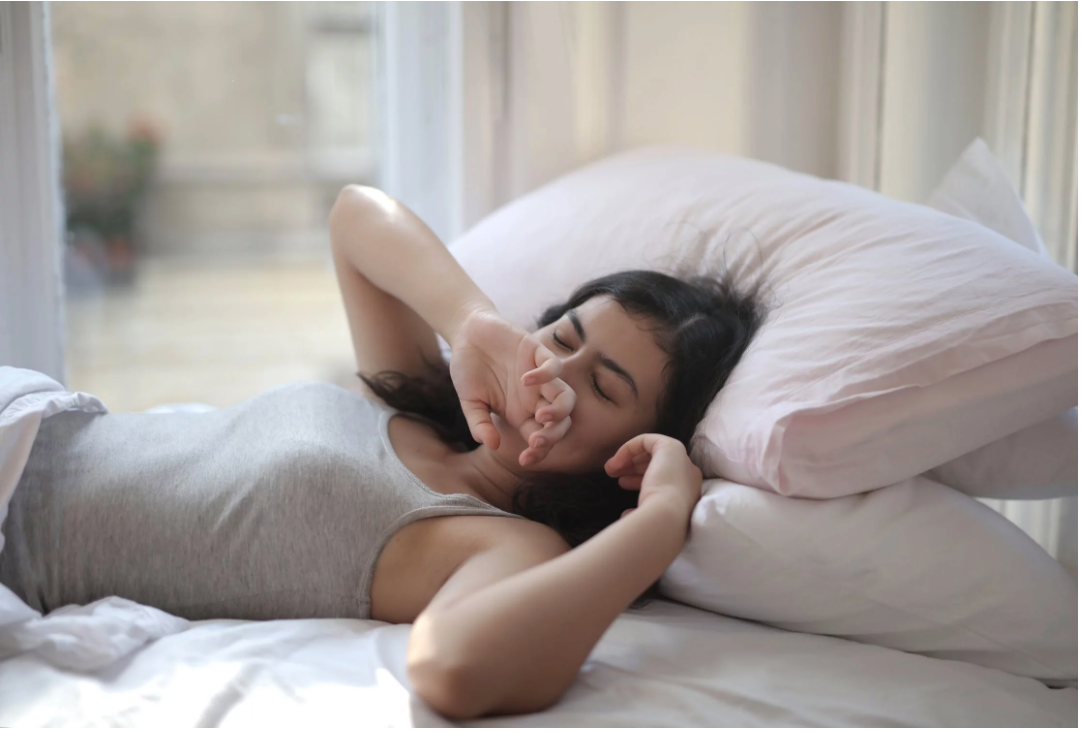 Woman in bed waking up